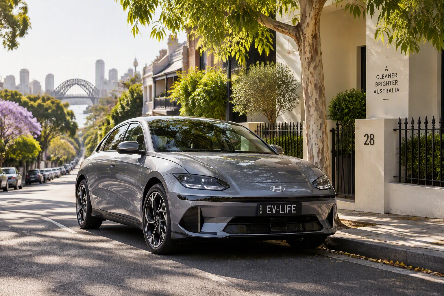 A grey electric sedan parked on a leafy Sydney terrace street